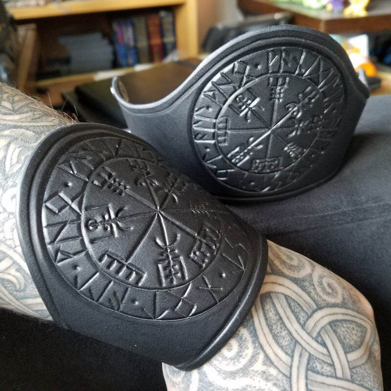 Black cuffs with the runic compass on them.